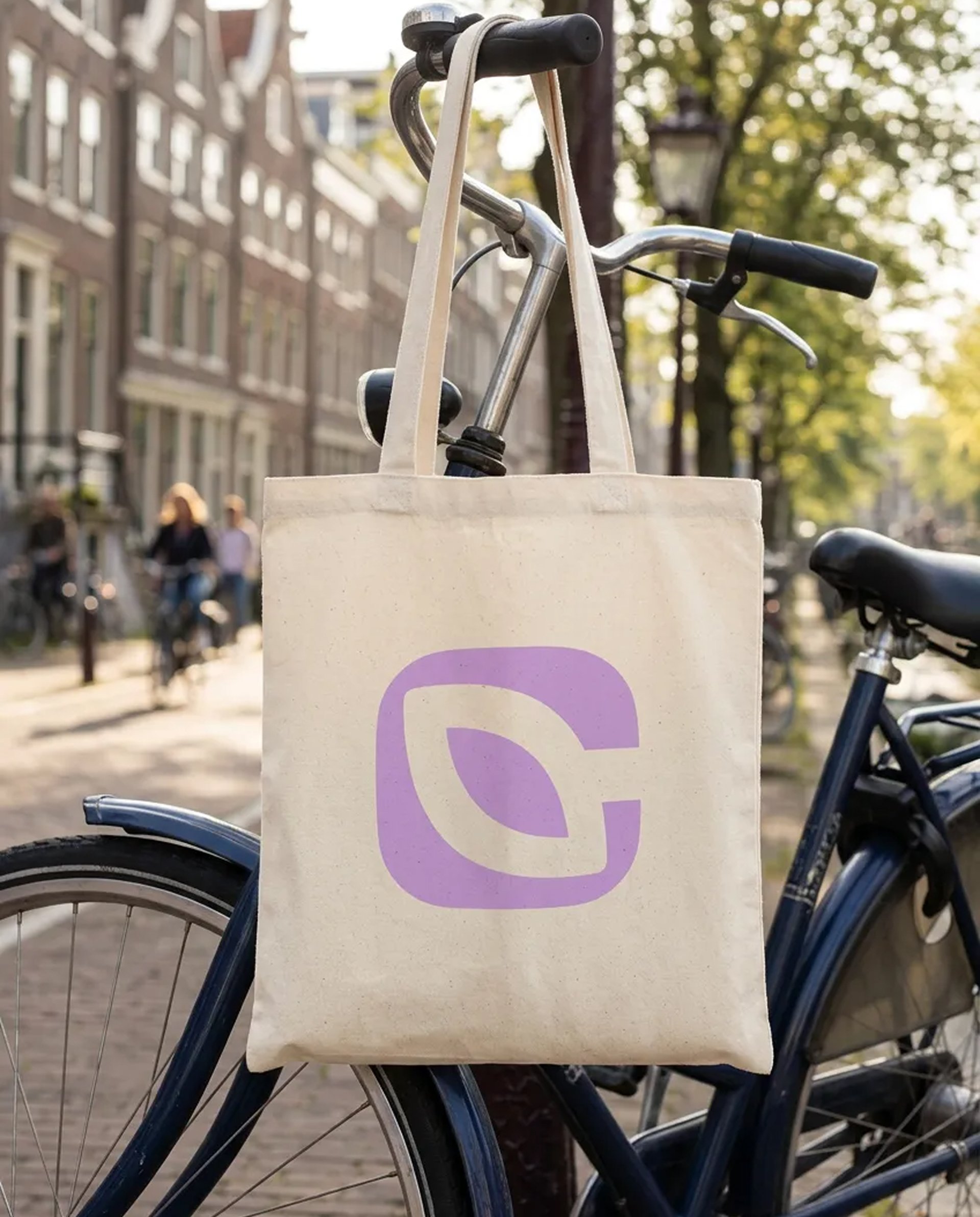 Climascapes leaf logo on a tote bag hung from a bicycle