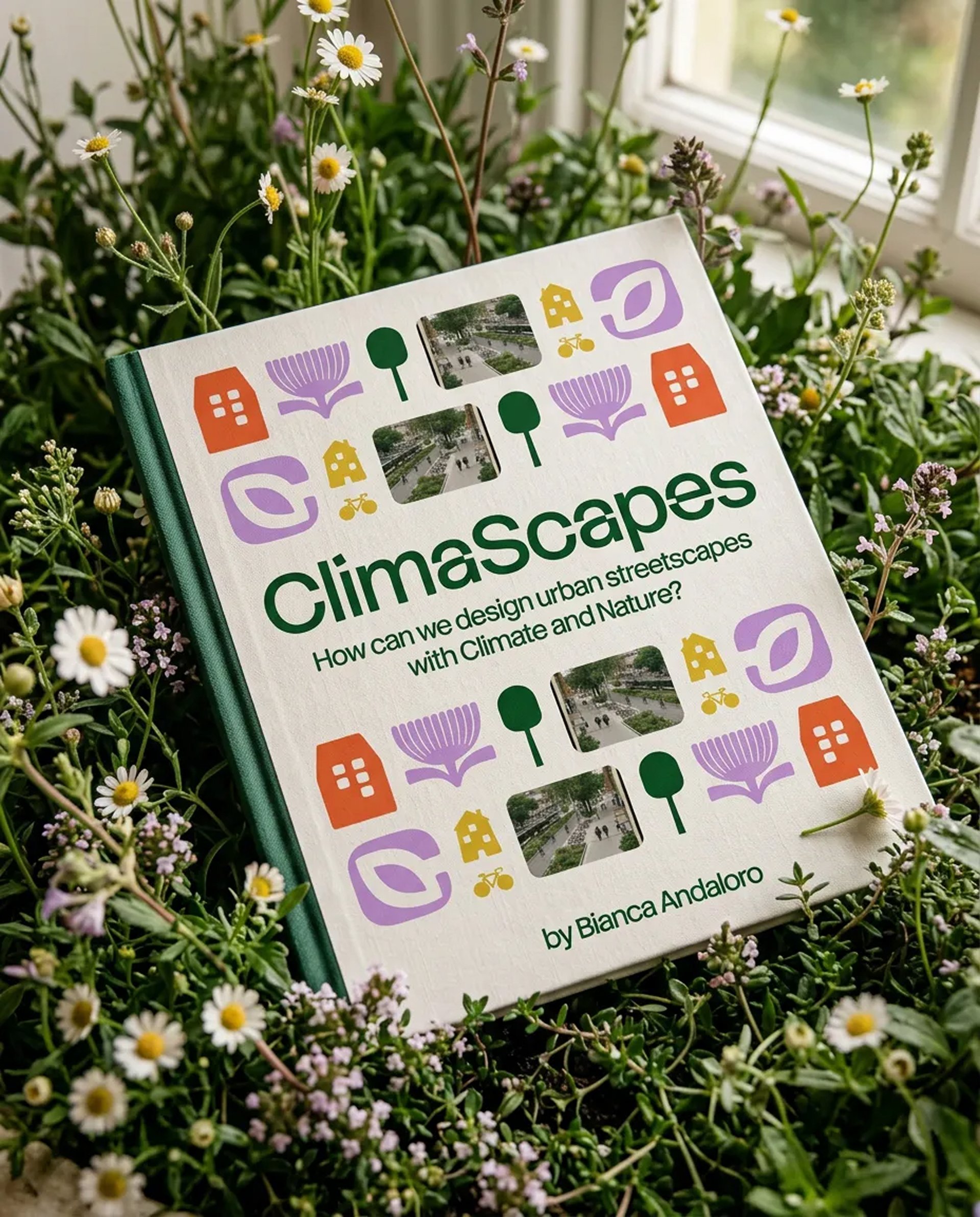 ClimaScapes book by Bianca Andaloro resting among wildflowers