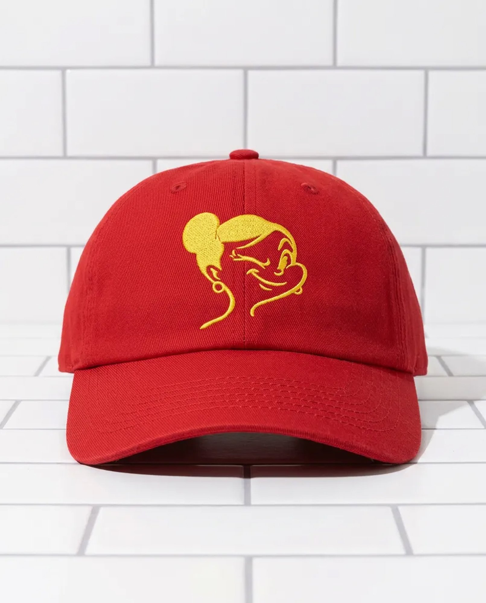 Red cap embroidered with the yellow Mrs Squizzi face logo